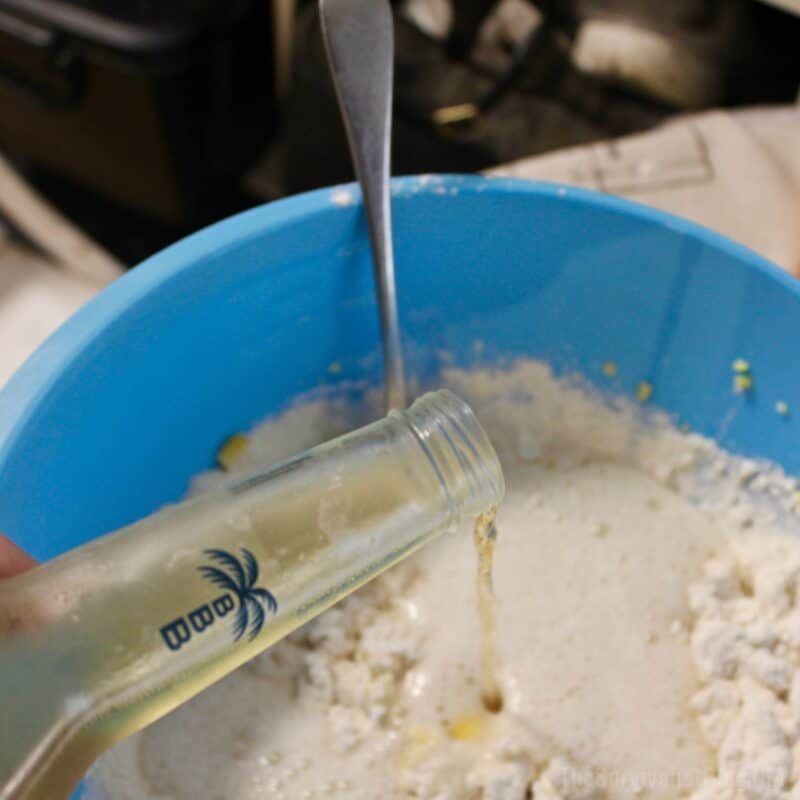 adding the beer to the self rising flour and corn
