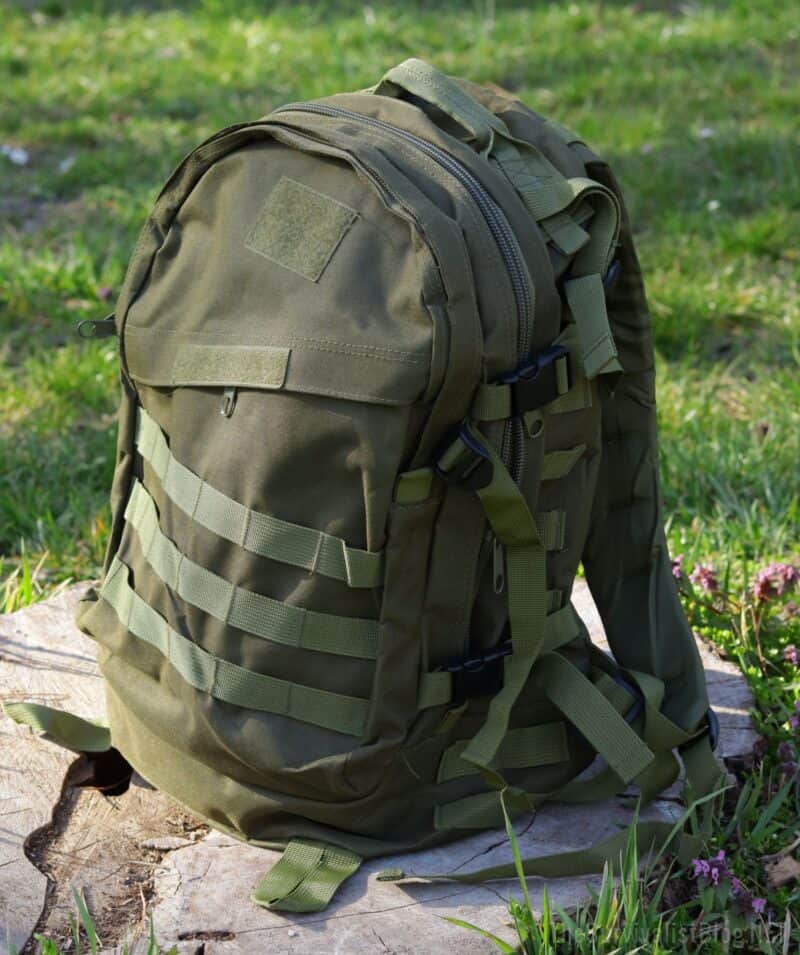 a green backpack with molle webbing